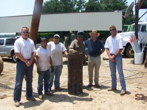 Nacho Esquibel and Gus Yanez look on as Emilio Yanez fabricates a new relift basket for irrigation well