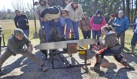 Travis Rushing (left) and Tabitha Holloway won the Jack and Hill crosscut saw competition with a time of 29.7 seconds.