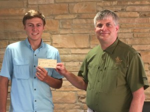 Dr. Glenn Manning, UAM Faculty, presents Clayton Whitaker with $500 scholarship check. Whitaker is a senior at UAM majoring in Natural Resources Management.