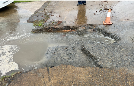 Close-up photo of Washed out street repair on East Davis