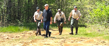 B259C927-73F1-468A-B24C-A1585EB3DE1AThis photo shows for Arkansas game and Fish commission officers who were on the phone with the man, locating him, but unable to contact him quickly, because of the thick underbrush.